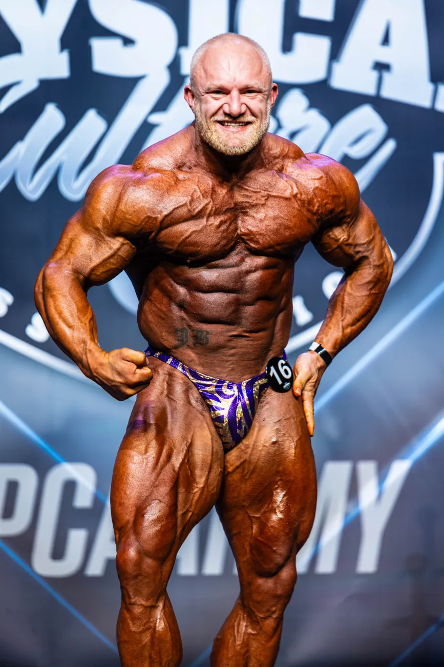 Bodybuilder in a front lat spread on stage