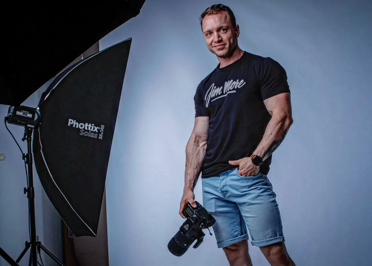 James of Studio Artwa in his studio, holding a camera